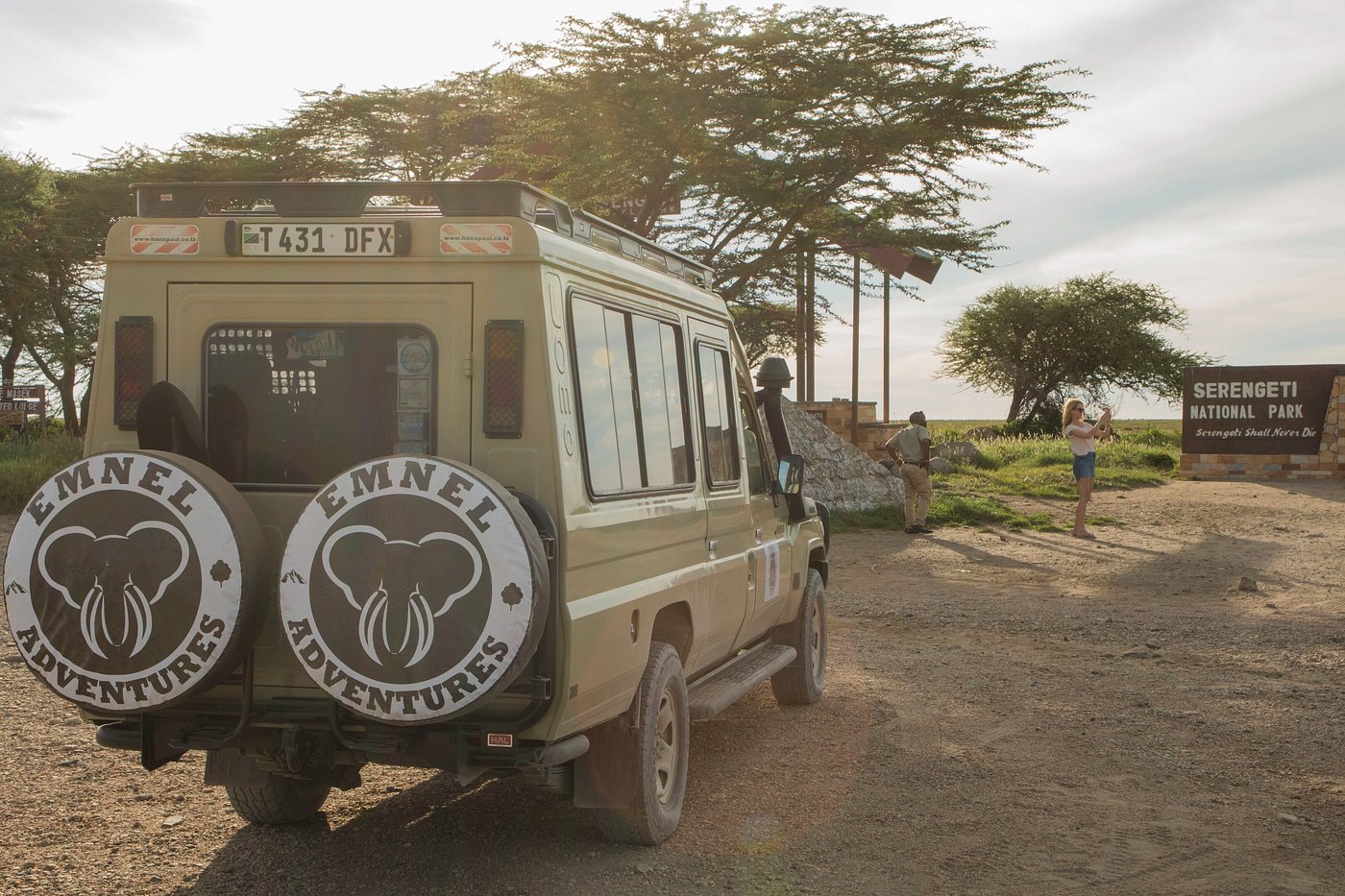 Emnel Adventures — a Tanzanian safari team on the Serengeti plains at golden hour